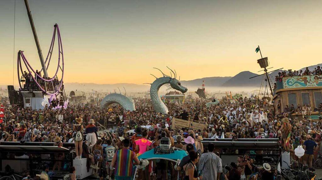 crowd and art cars at burning man